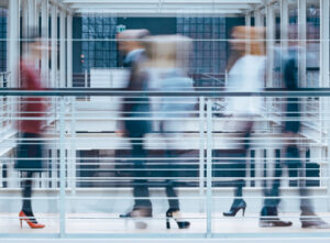International Business, people walking fast, blurred images